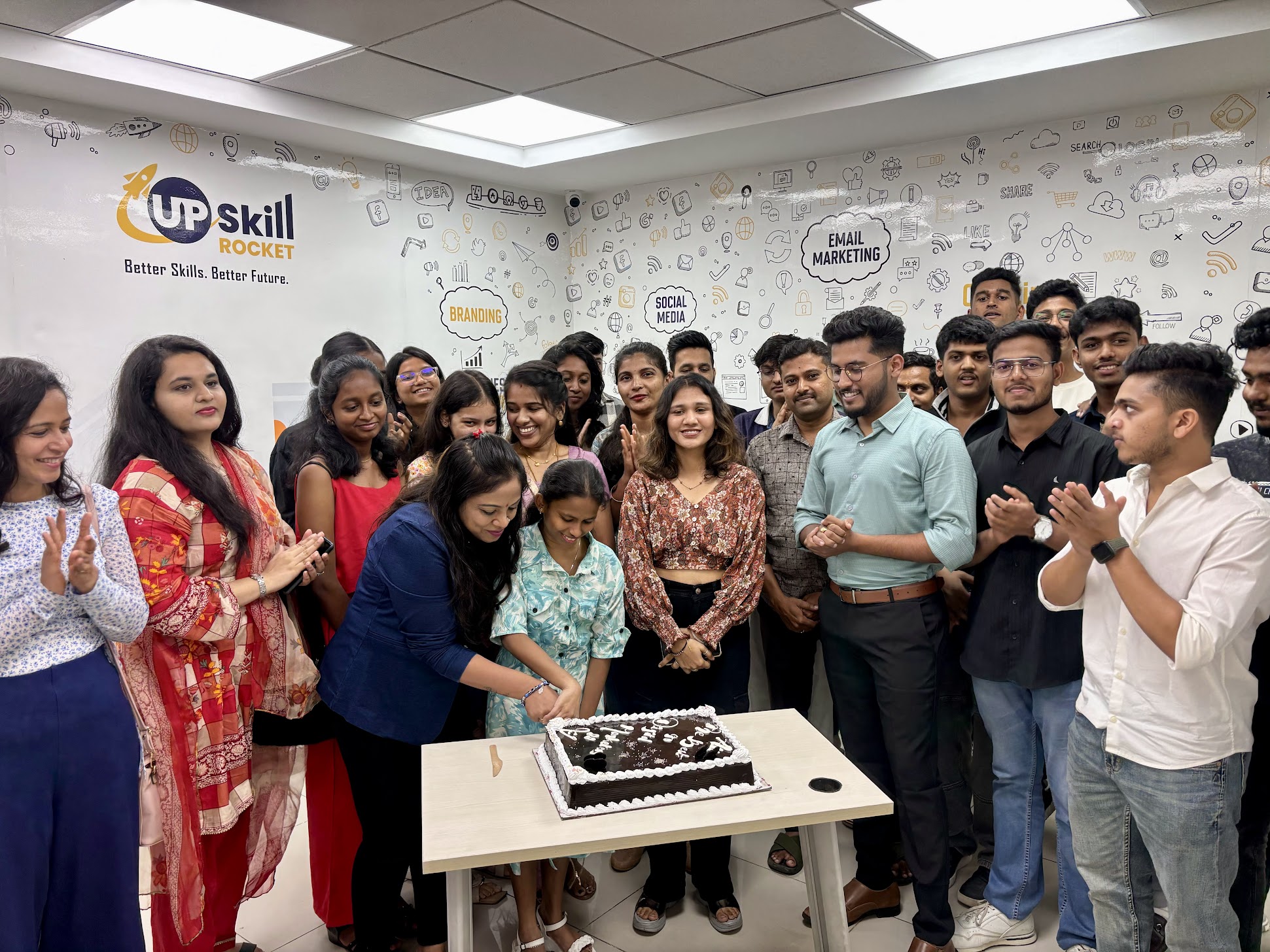 Upskill Rocket students celebrating with a cake in the classroom